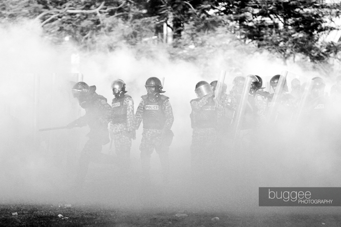 Riot policemen stand in a cloud of tear gas fired by army soldiers in a short-lived standoff between the police and army in the Republican Square hours before former President Mohamed Nasheed stepped down on February 7.