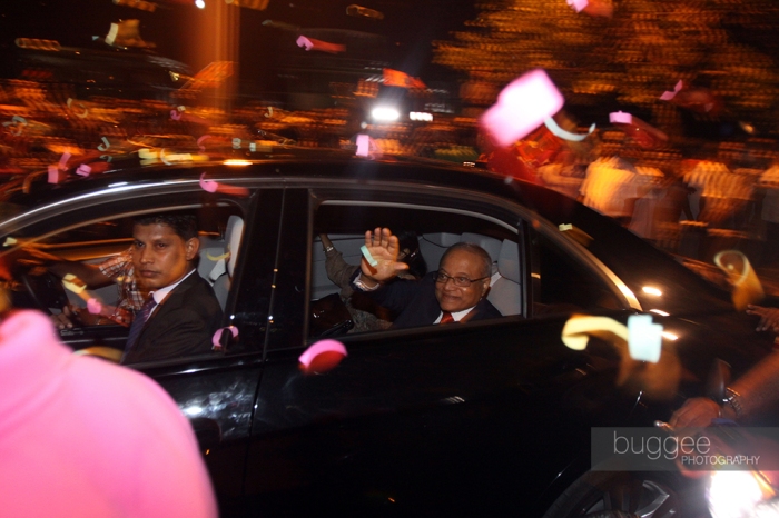 Former President Maumoon Abdul Gayoom gestures to supporters as he is driven away in a car shortly after returning to Male for the first since his rival Mohamed Nasheed stepped down as President on February 7.