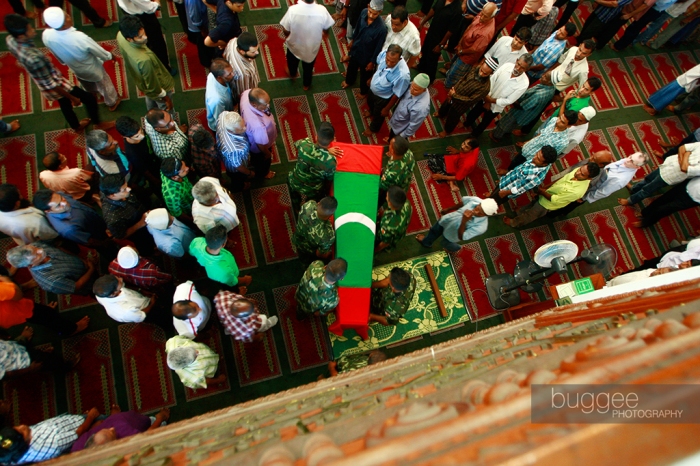 The coffin of slain MP Dr. Afrasheem Ali is taken away for burial following funeral prayers.